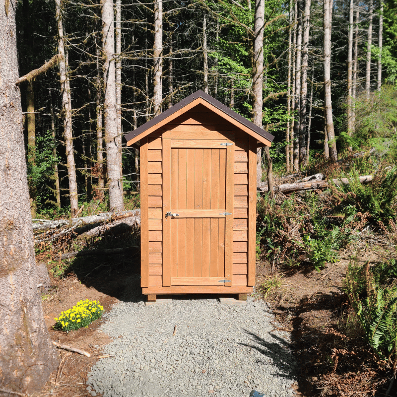 Front view of the DIY Oregon Timber Werks outhouse kit, highlighting rustic design, craftsmanship, and eco-friendly features for homesteading.