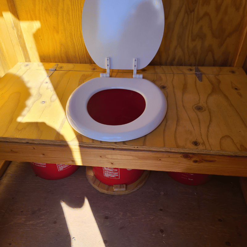 Inside view of the Oregon Timber Werks outhouse seat, highlighting rustic design, craftsmanship, and eco-friendly features of the DIY kit suitable for homesteading.